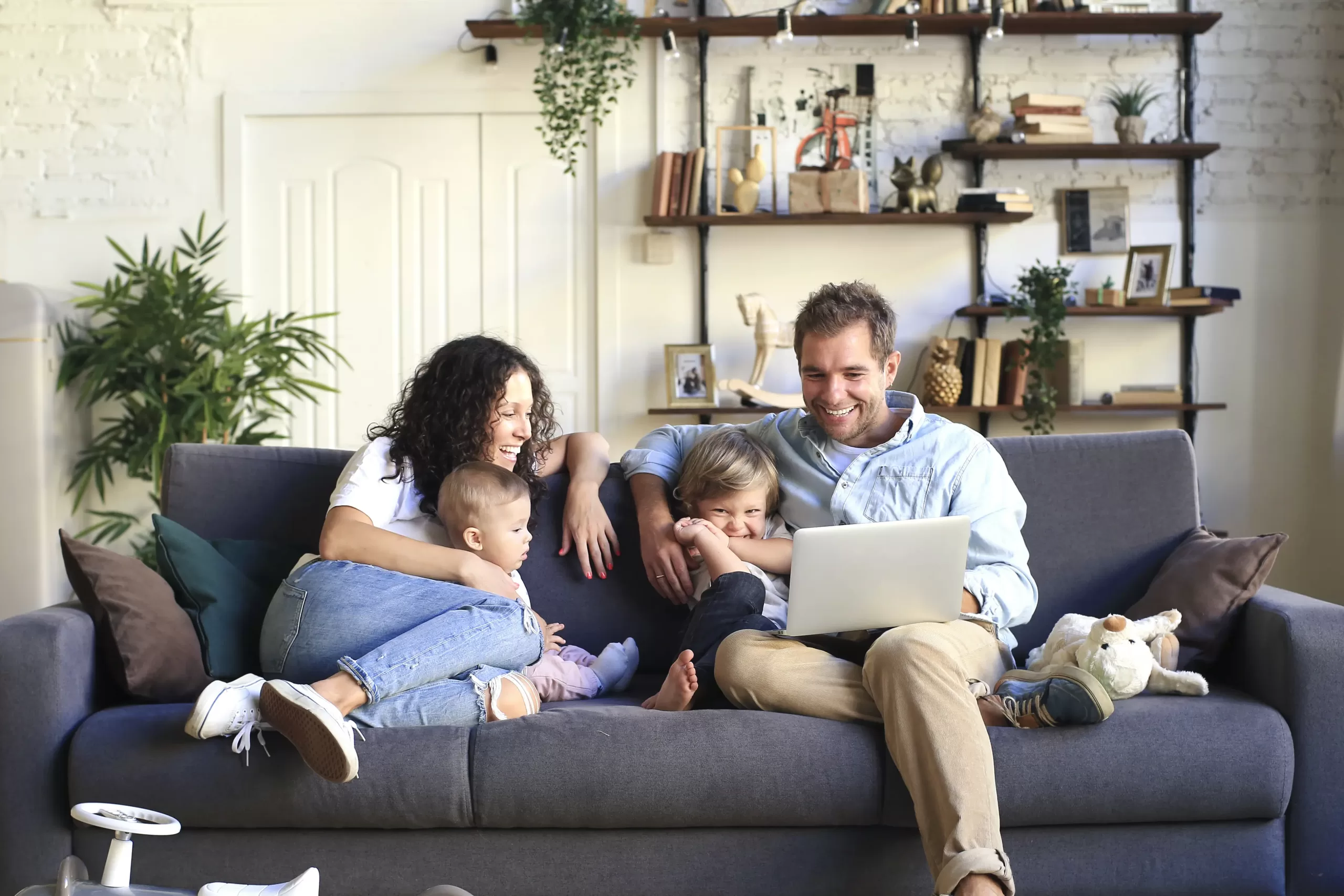 Family sit together on couch in lounge